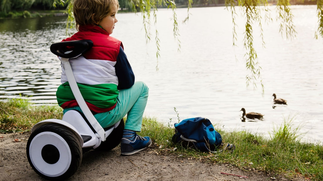 Kid sitting on a rideo hoverboard