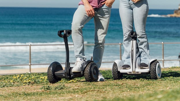 Two person standing on rideo hoverboard