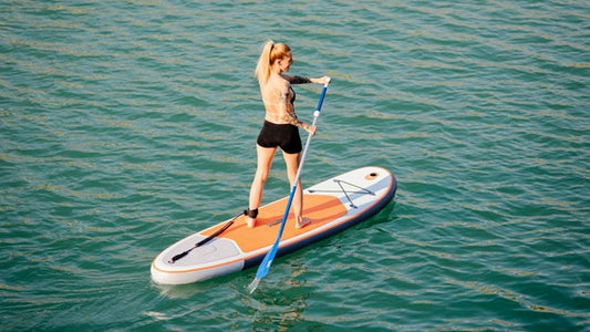 Woman riding rideo paddleboard in ocean