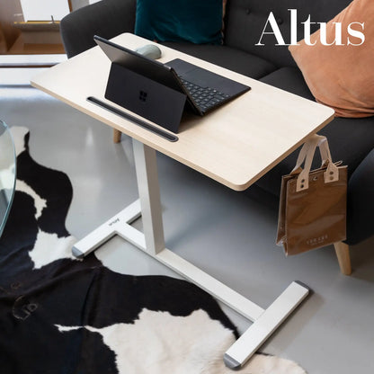 workspace setup with the desk in a home environment, a woman comfortably using her laptop, demonstrating the desk's practicality and aesthetic appeal in personal spaces.