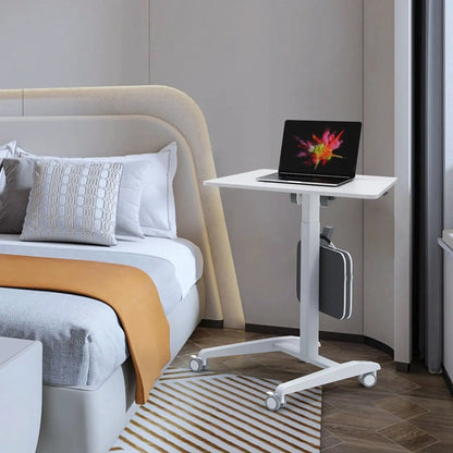 White sit-stand desk in a bedroom setup showing its versatility in home environments.