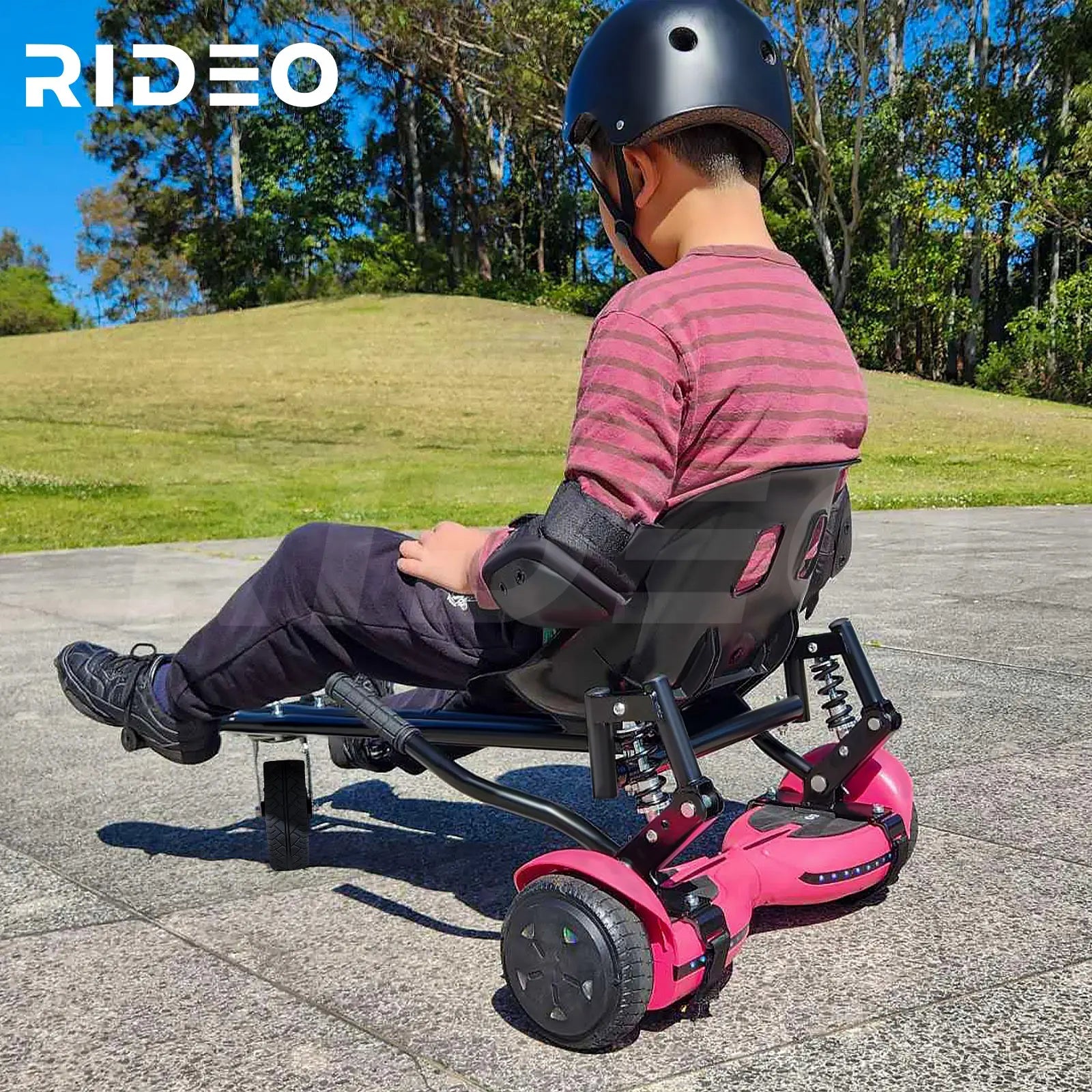 A child enjoys a sunny day out riding the RIDEO Hoverboard Go-Kart in a striking pink color, showcasing the fun and safety of the model.